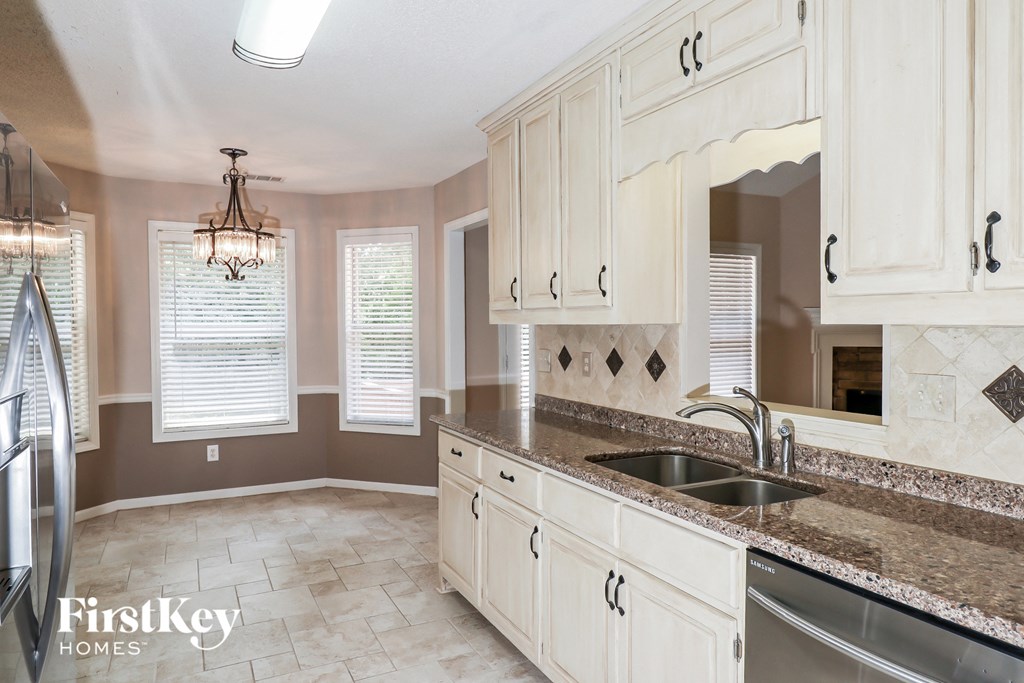 a kitchen with white cabinets and a sink