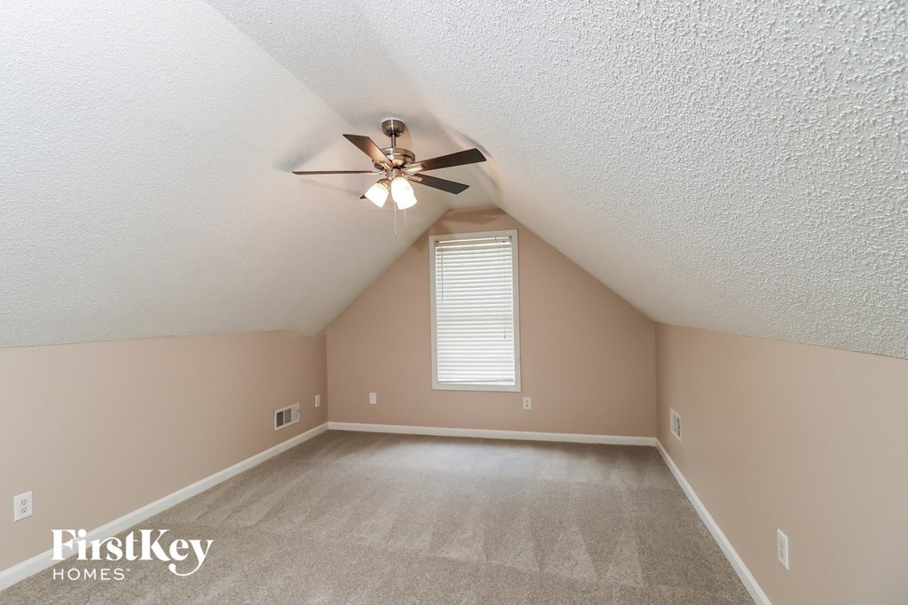 the bonus room is spacious and has a ceiling fan