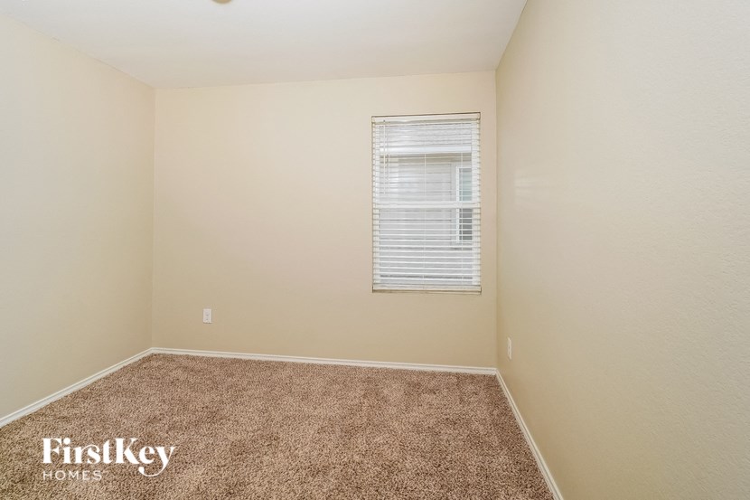 a room with a carpeted floor and a window