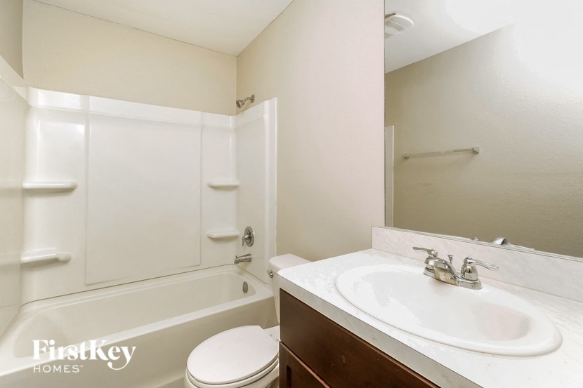 a bathroom with a sink and a toilet and a bath tub