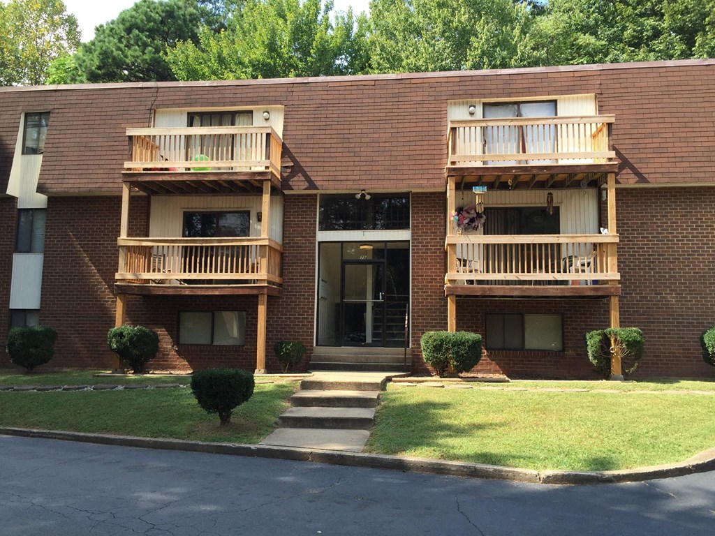 the front of a brick apartment building with balconies