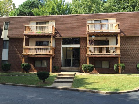 the front of a brick apartment building with balconies