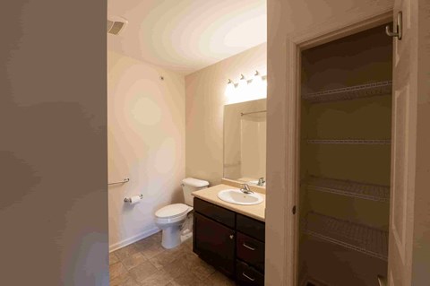 a bathroom with a sink toilet and a mirror