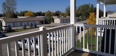 a view from the porch of a home with a white railing