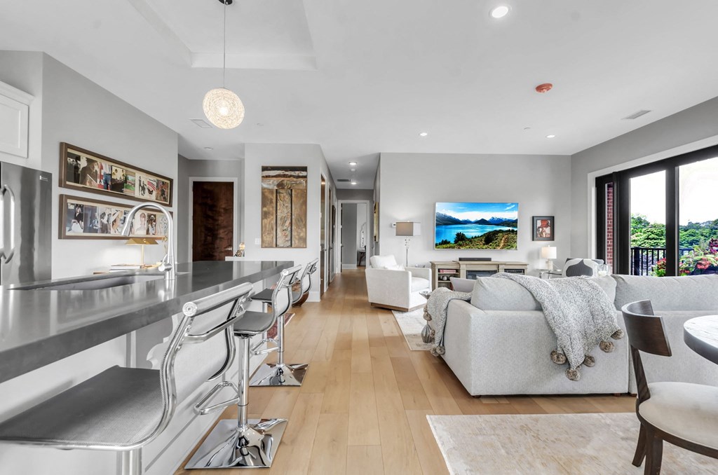 the living room is open to the kitchen and dining room