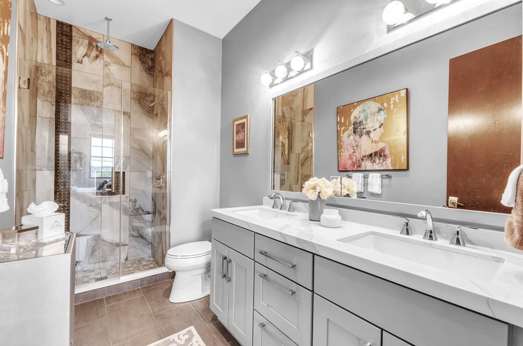 a bathroom with a sink and a shower and a toilet