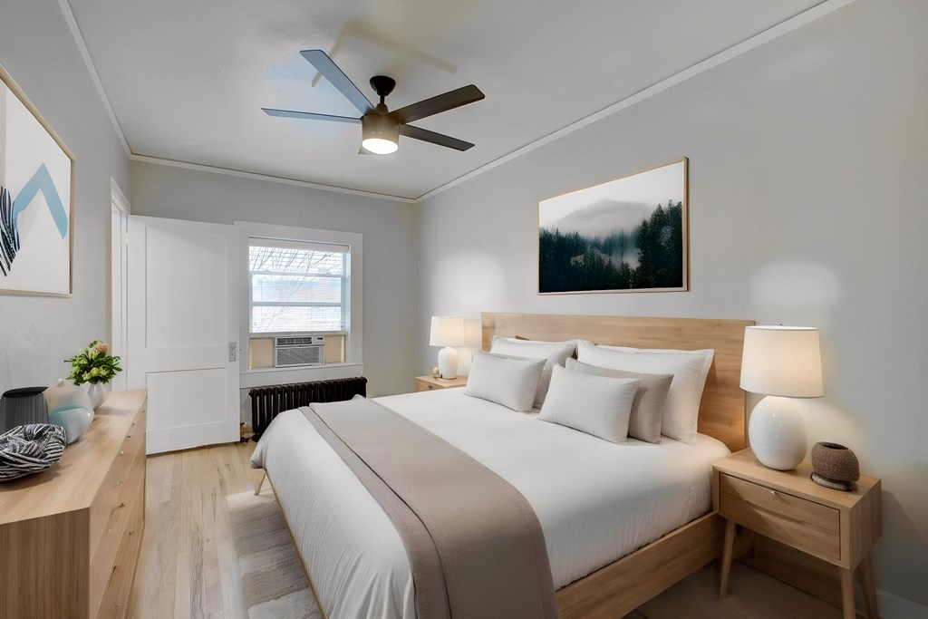 a bedroom with a large bed and a ceiling fan