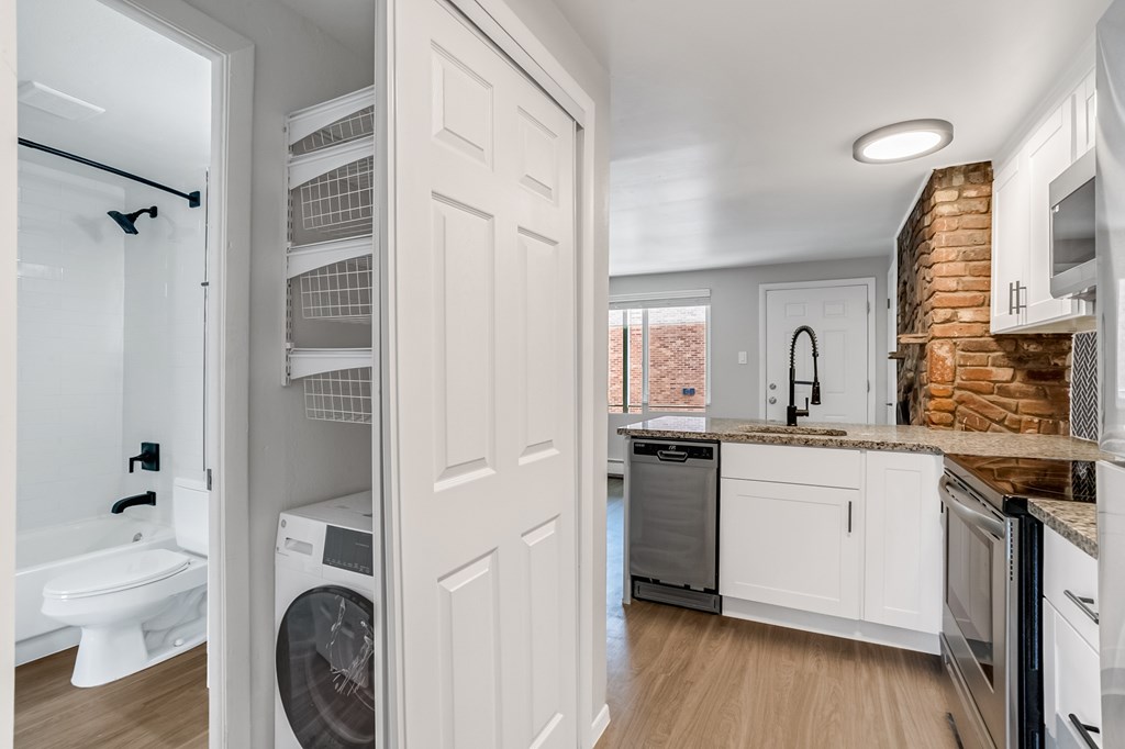 A white laundry room with a washer and dryer.