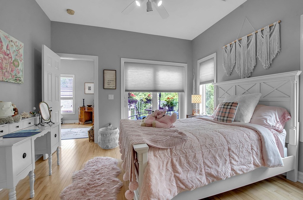 a bedroom with a bed and a dresser and a window