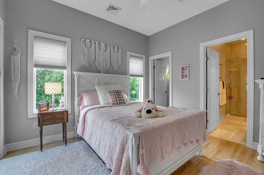 a bedroom with a bed and a door to a bathroom