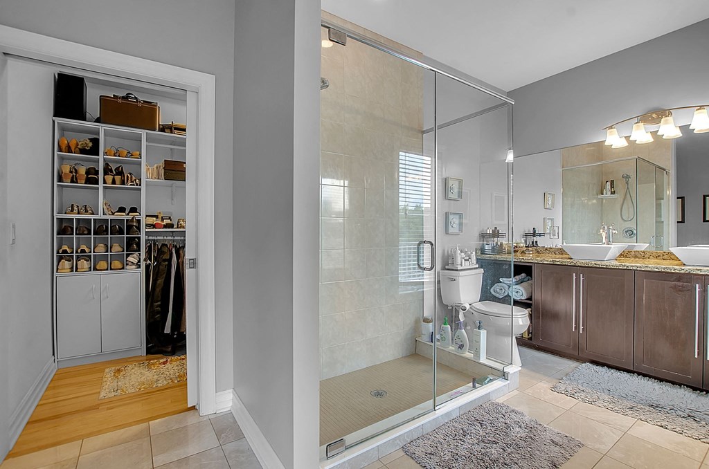 a bathroom with a shower and a sink and a mirror