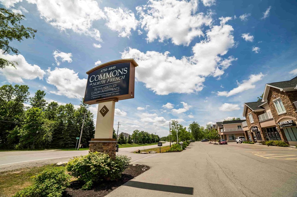 the sign at the end of the street in front of a building