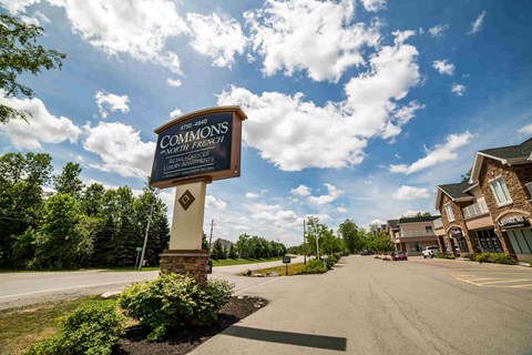 the sign at the end of the street in front of a building