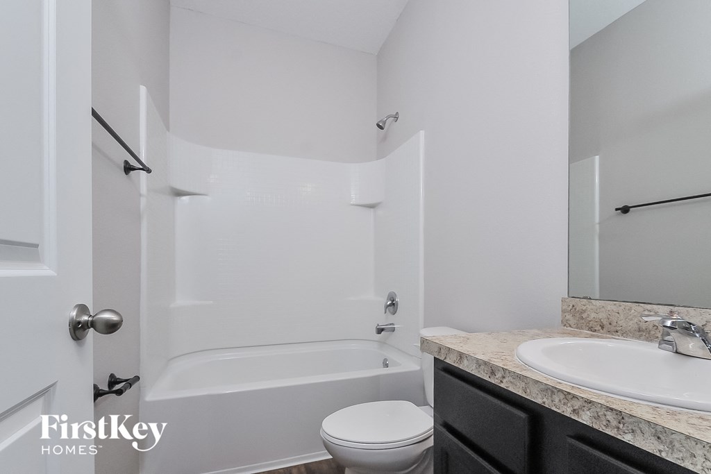 a bathroom with a sink toilet and shower and a tub
