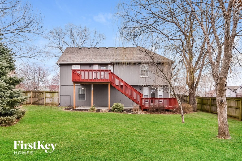 A house with a red staircase and a grey roof.