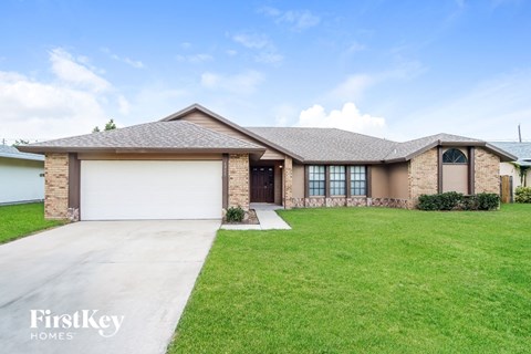 a house with a lawn and a driveway