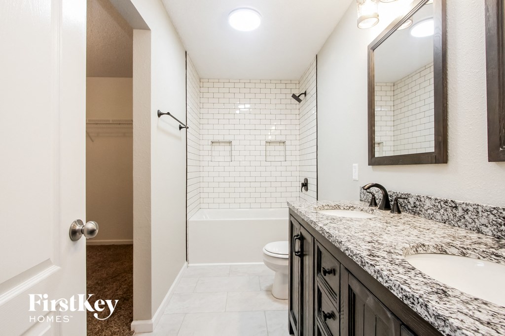 a bathroom with a shower and a sink and a toilet