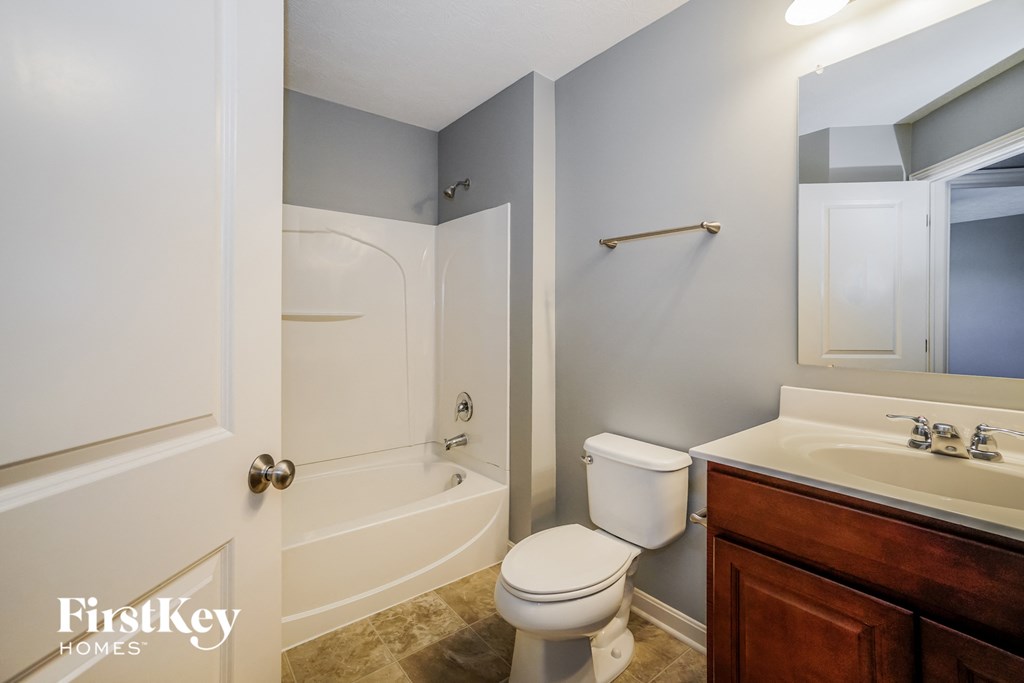 a bathroom with a toilet and a sink and a shower