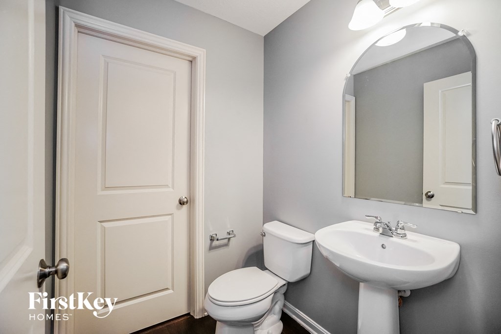 a small bathroom with a sink toilet and a mirror