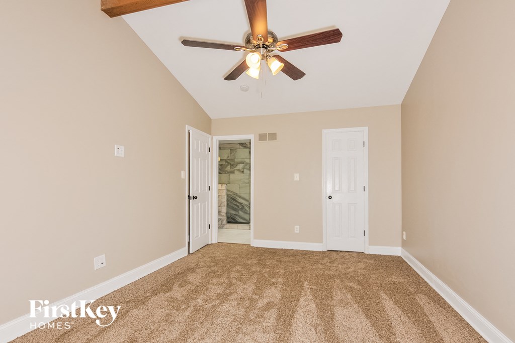 the master bedroom is spacious and has a ceiling fan
