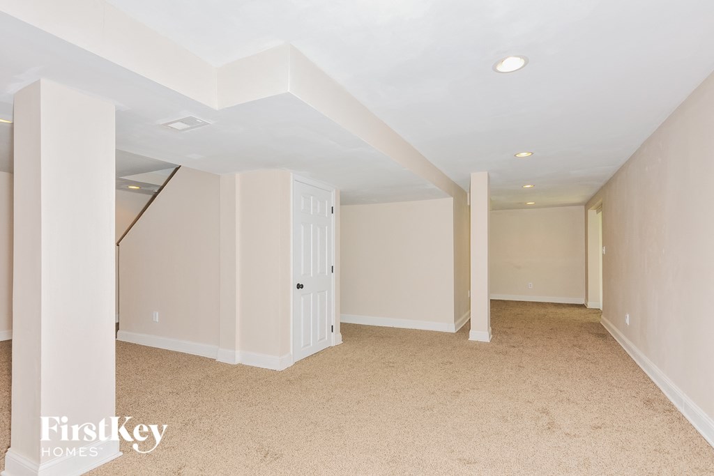 a bedroom with white walls and a carpet floor and a white closet