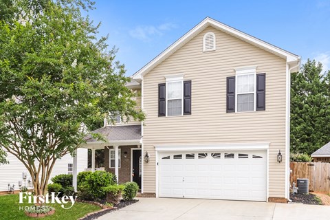 a yellow house with a white garage door