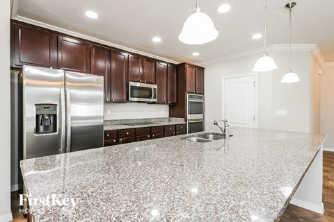 a kitchen with a marble counter top and stainless steel appliances