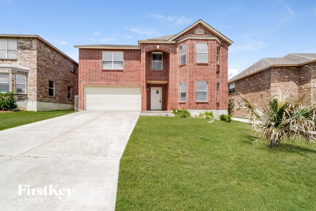 a large brick house with a sidewalk in front of it