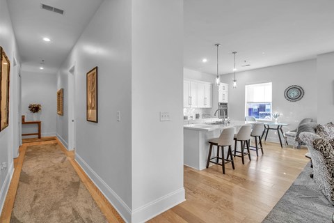 a living room and kitchen with a dining area and a kitchen island