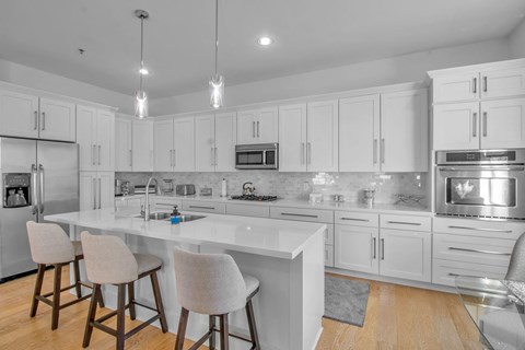 a kitchen with white cabinets and a white counter top