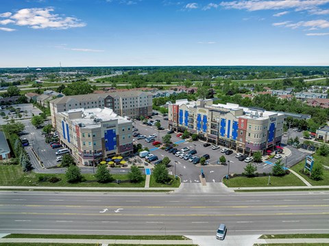 an aerial view of a city with buildings and a street