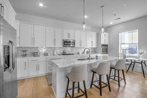 a kitchen with a large island and bar stools
