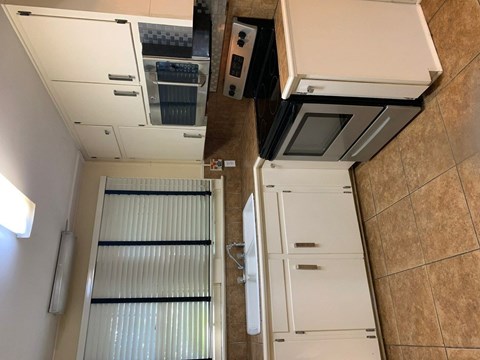 a kitchen with a refrigerator and a stove and