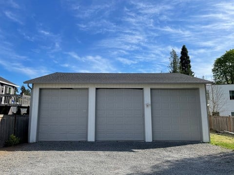a garage with a blue sky above it