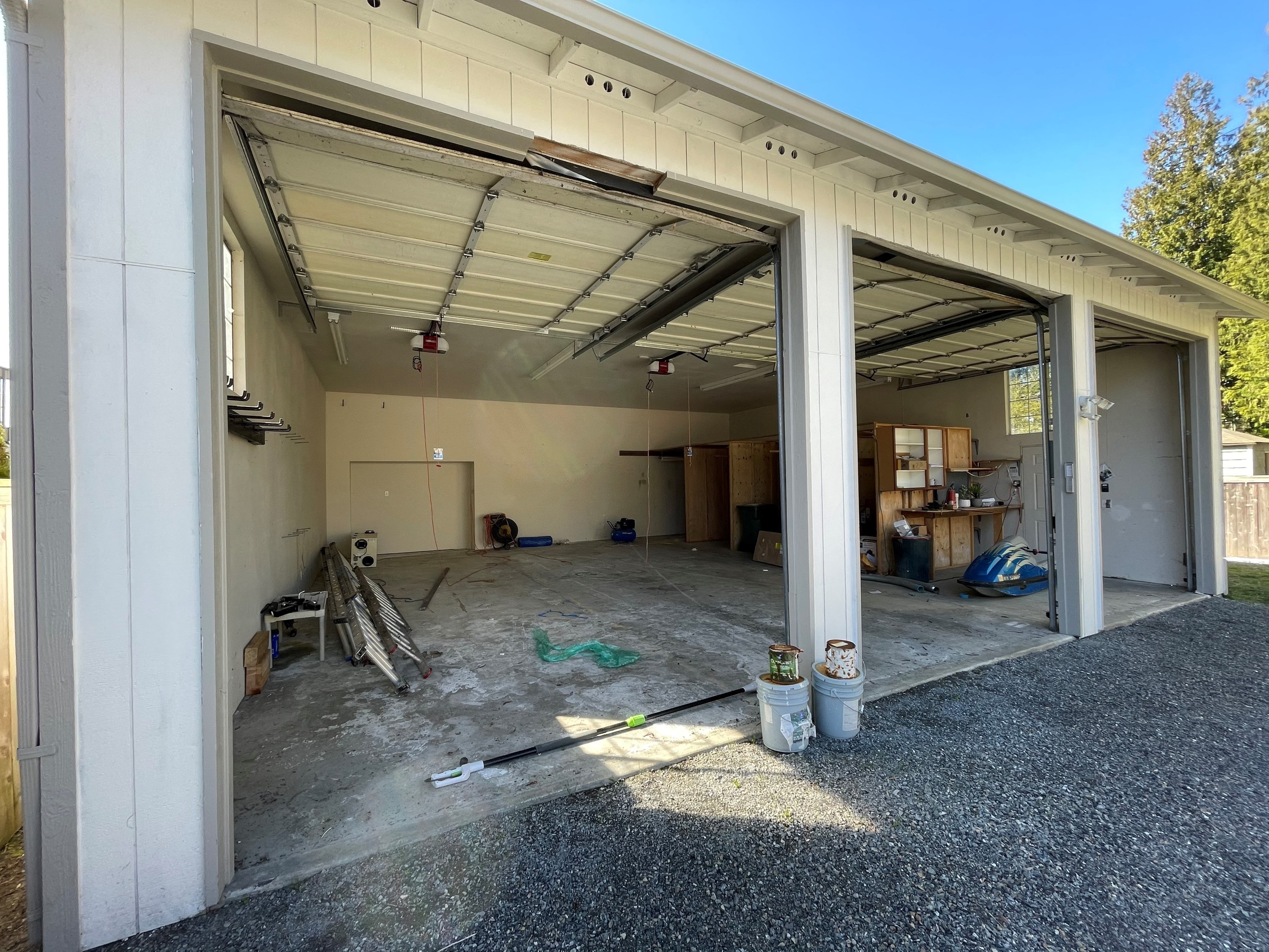 the inside of a garage with the doors open