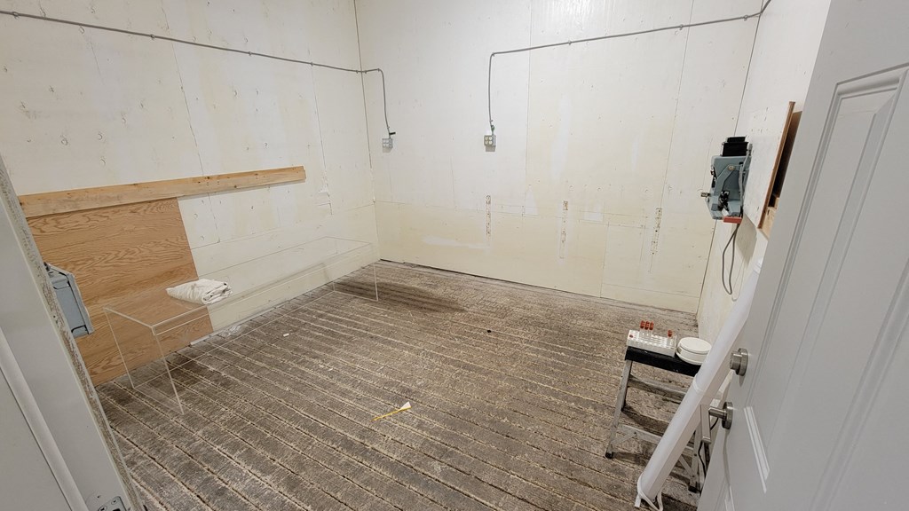 a bathroom being remodeled with wood flooring and white walls