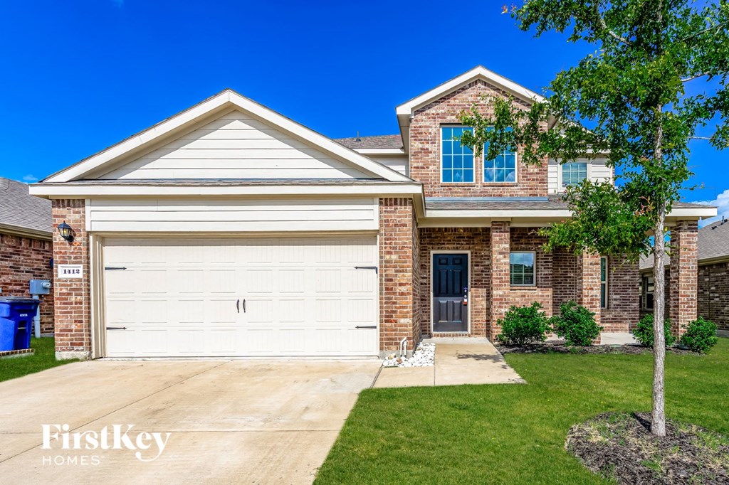 a brick house with a white garage door