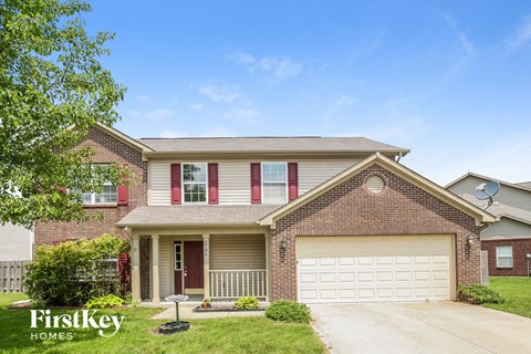 a brick house with a white garage door