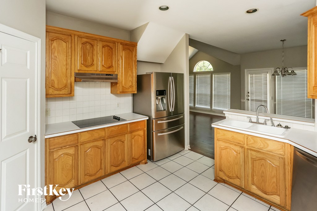 a kitchen with wooden cabinets and stainless steel appliances