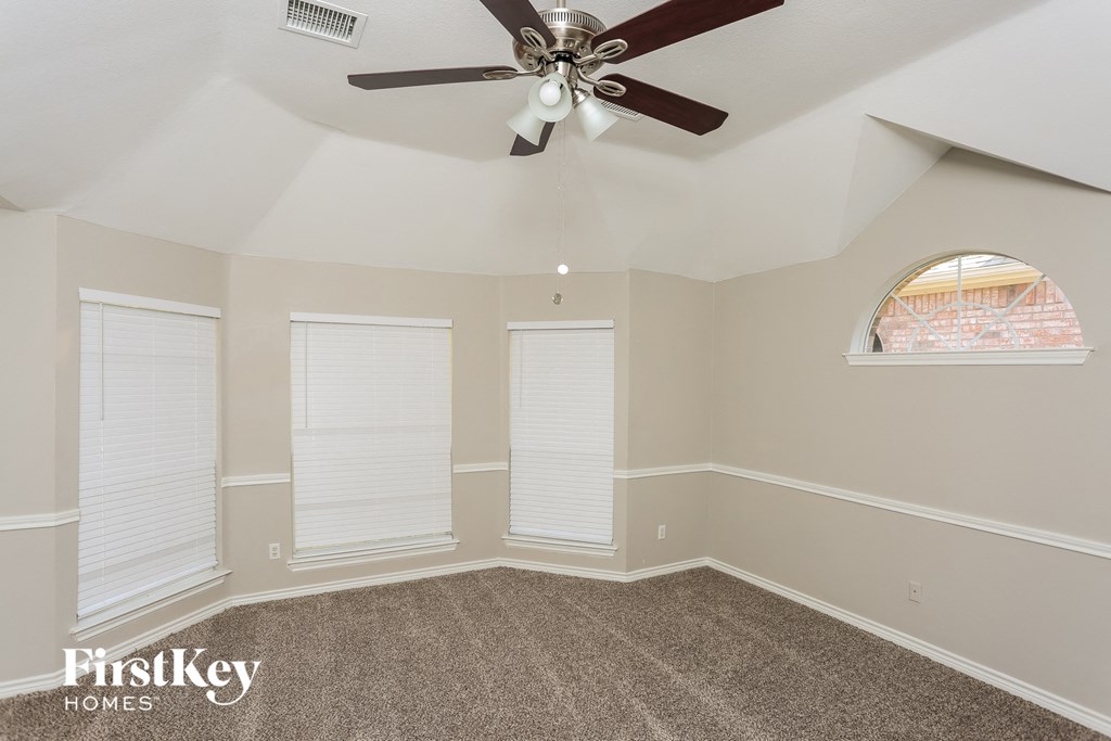 the living room of a home with a ceiling fan