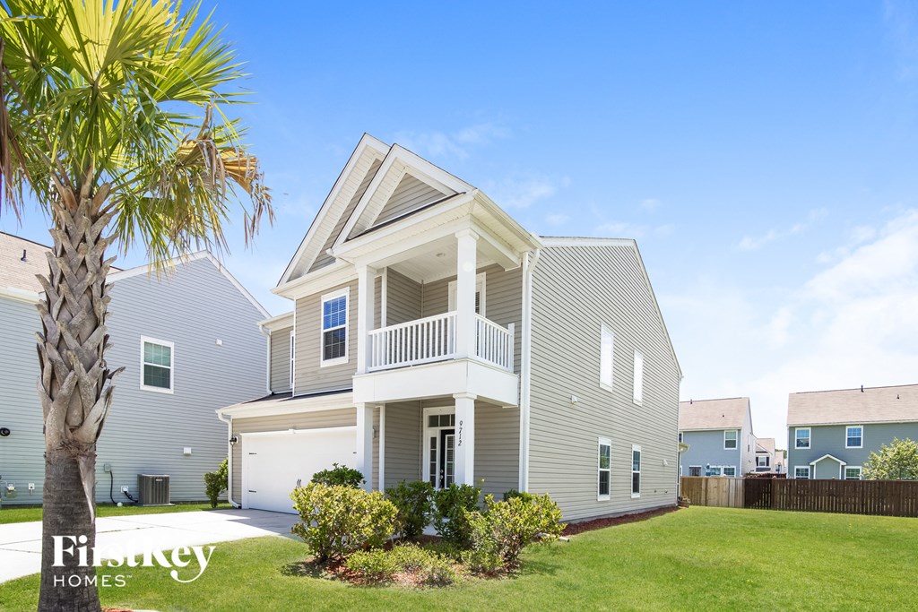a white house with a palm tree in front of it