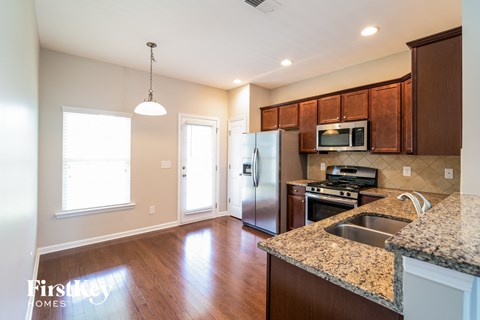 a kitchen with granite counter tops and stainless steel appliances