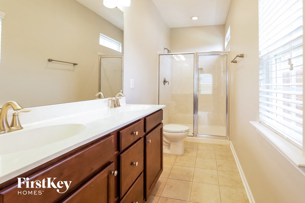 a bathroom with a sink and a shower and a toilet