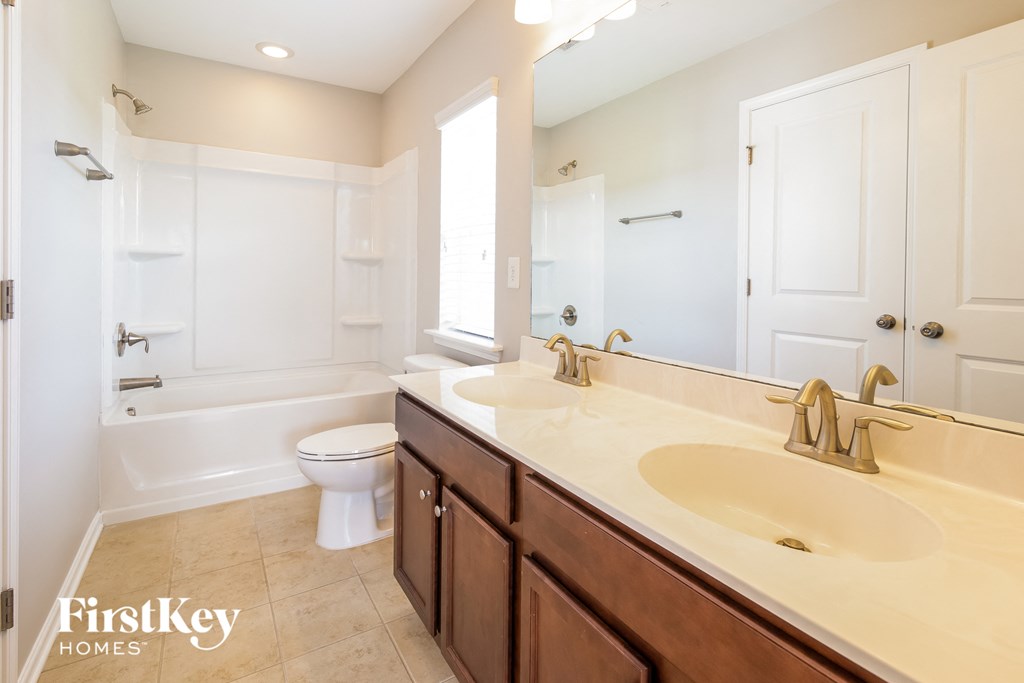 a bathroom with a sink and a toilet and a bath tub