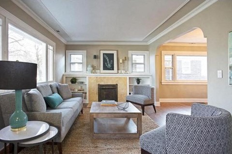 a living room with a couch and chairs and a fireplace