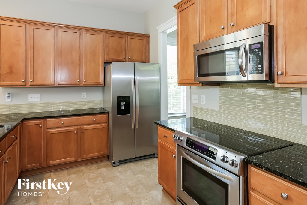 a kitchen with stainless steel appliances and wooden cabinets