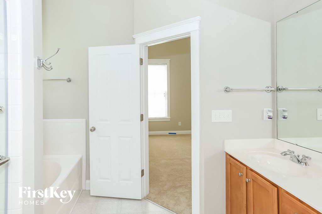 a bathroom with a sink and a mirror and a shower