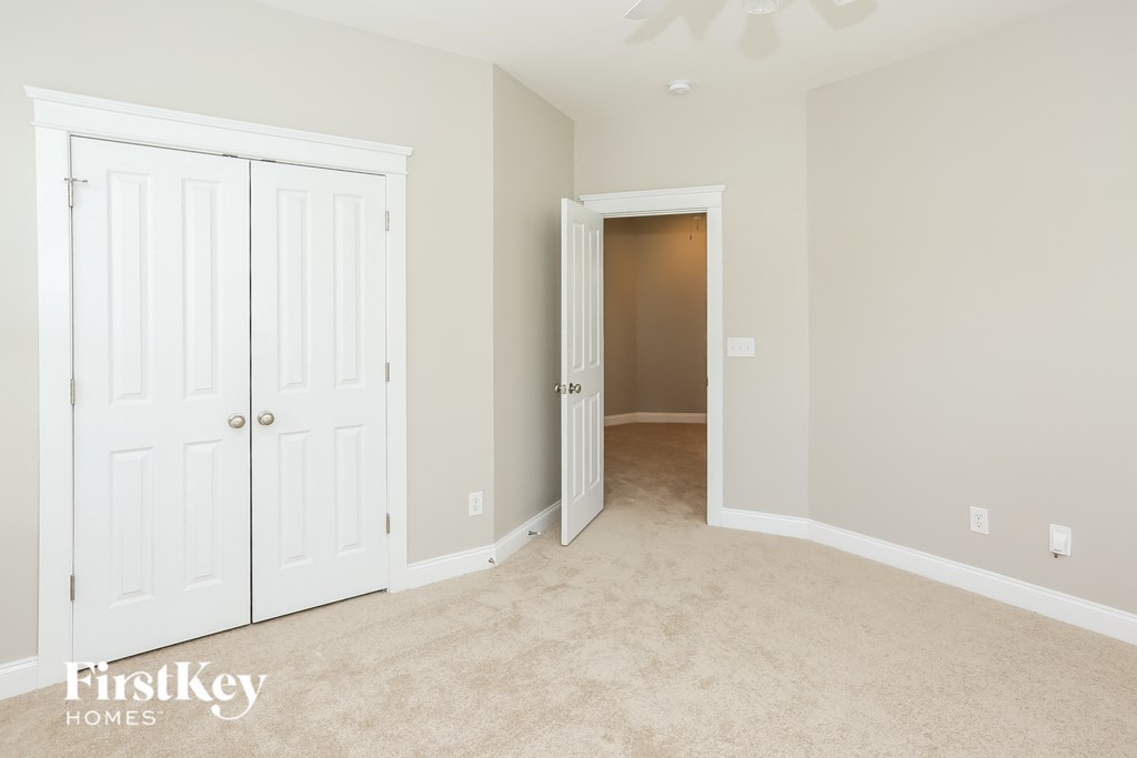 a bedroom with two closets and a door to a hallway