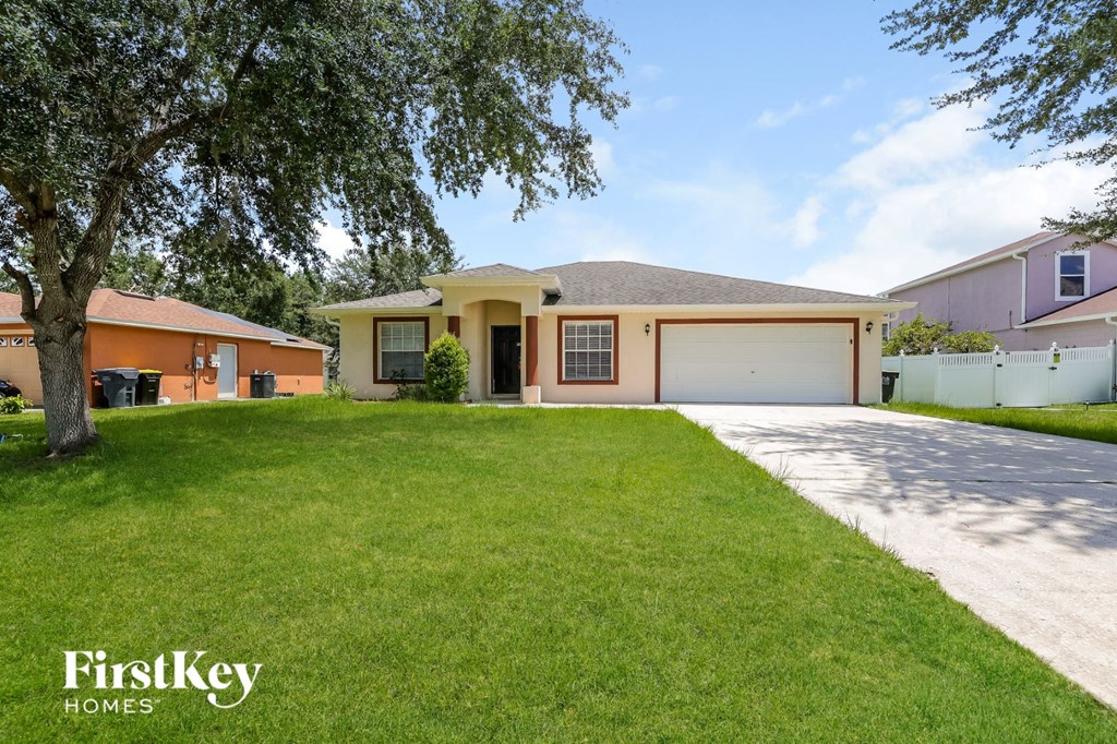 a home with a lawn and a garage