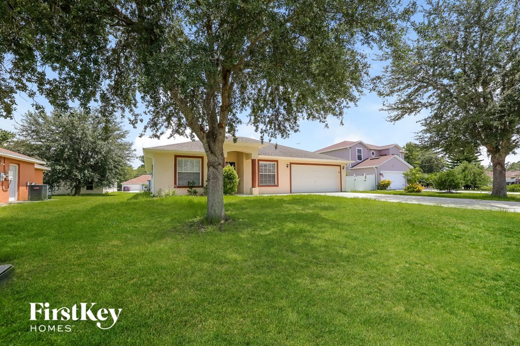 a home with a lawn and a tree